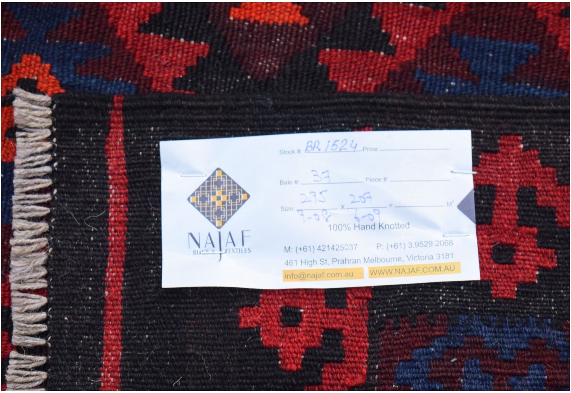 A handwoven Afghan Maimana Kilim featuring a geometric pattern in red, black, and blue wool.