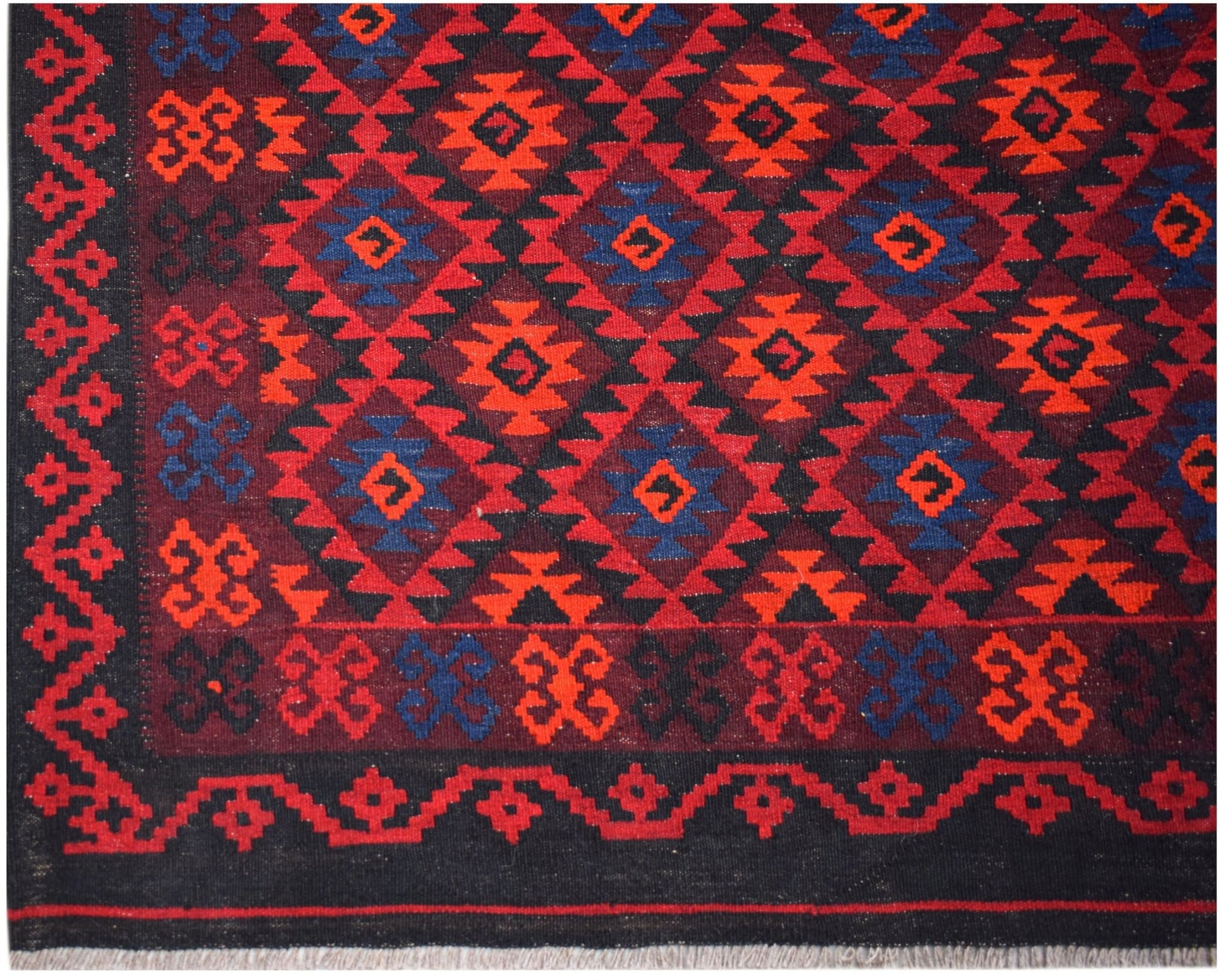 Handwoven Afghan Maimana kilim featuring a geometric diamond pattern in red, blue, and black.