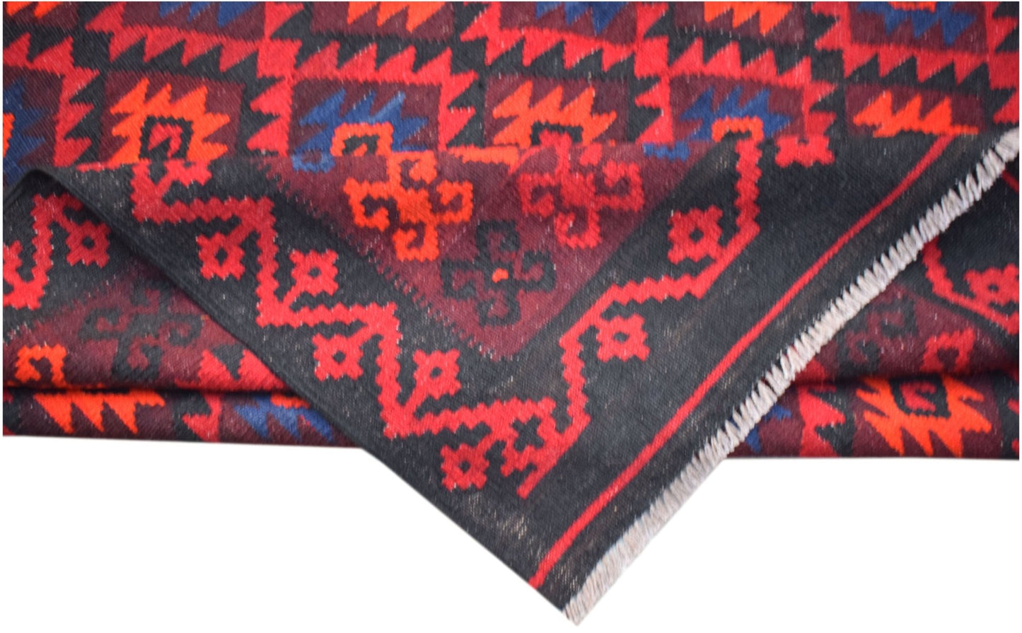 A handmade Afghan Maimana kilim featuring geometric patterns in red, black, and blue wool.