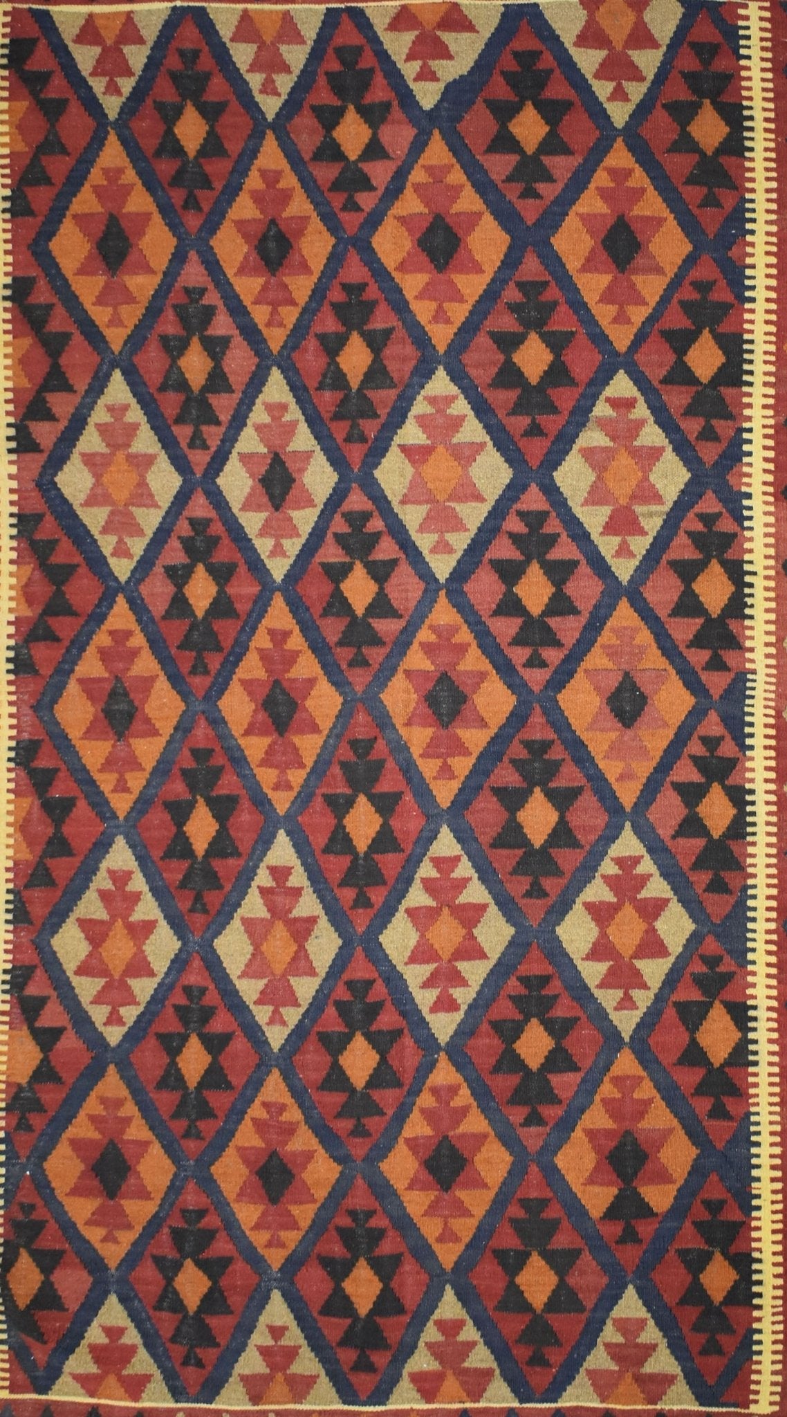 Handmade Afghan Maimana kilim rug featuring a repeating diamond pattern in warm earth tones.