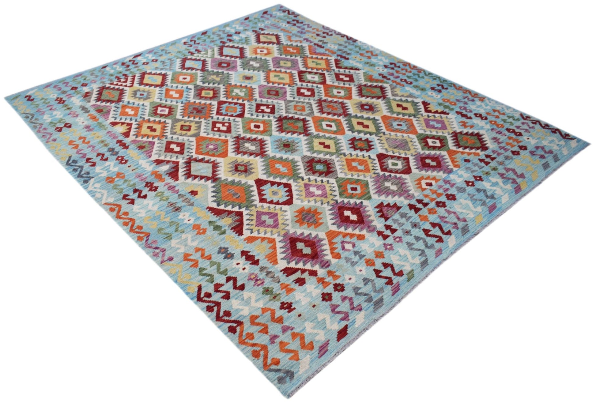 Handwoven Afghan Maimana kilim rug featuring a colorful geometric diamond pattern on a blue base.