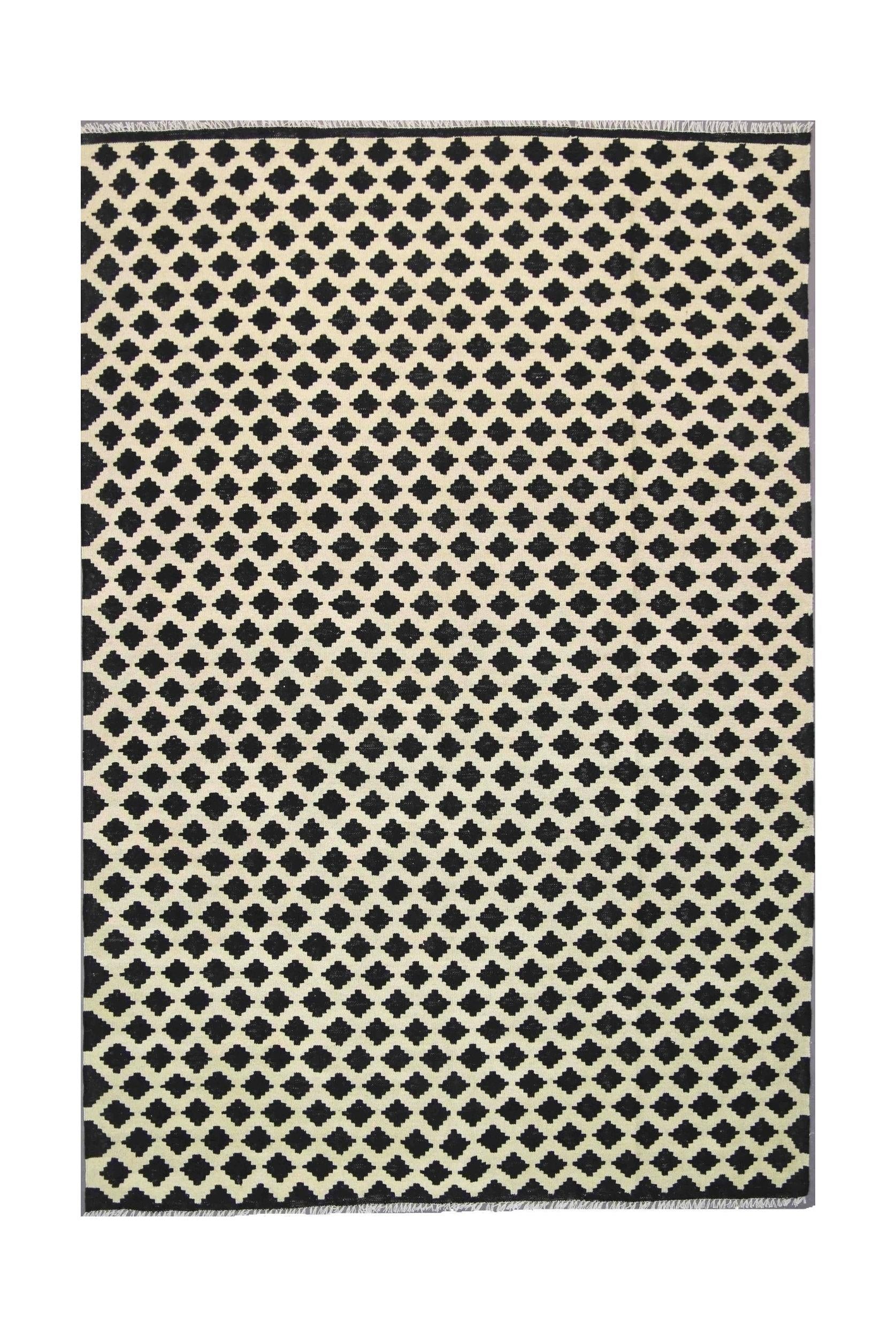 Handmade Afghan Maimana kilim rug featuring a repeating black and cream geometric pattern.