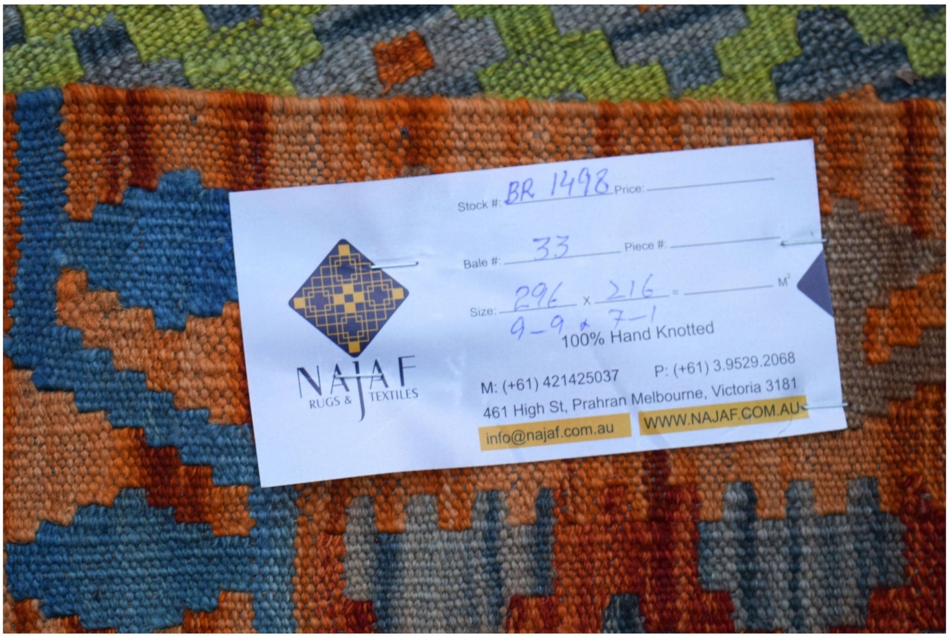 A handwoven Afghan Maimana kilim featuring a geometric pattern in orange, blue, and green tones.