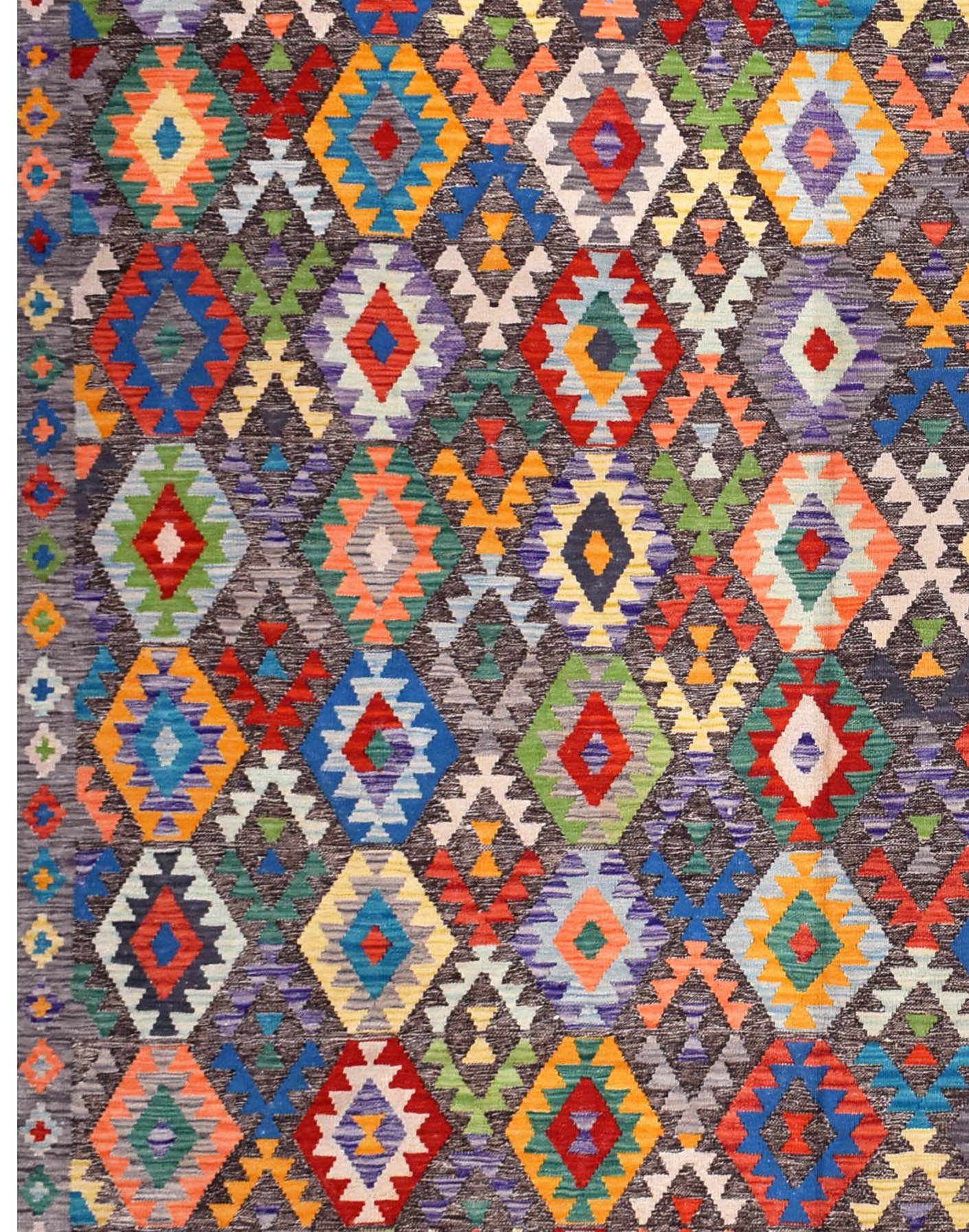 Handmade Afghan Maimana kilim rug featuring a colorful geometric diamond pattern on a dark ground.