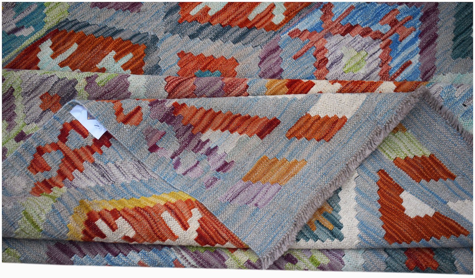 Handwoven Afghan Maimana kilim rug featuring a colorful geometric pattern and flatweave texture.