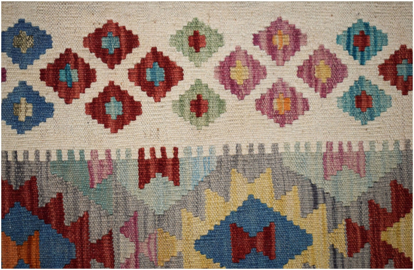 Handwoven Afghan Maimana kilim featuring a flatweave texture and colorful geometric patterns.