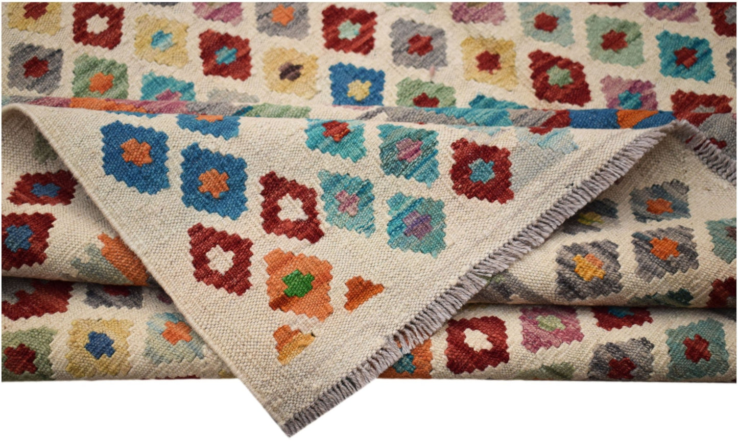Handwoven Afghan Maimana kilim rug featuring a colorful geometric pattern on a cream background.