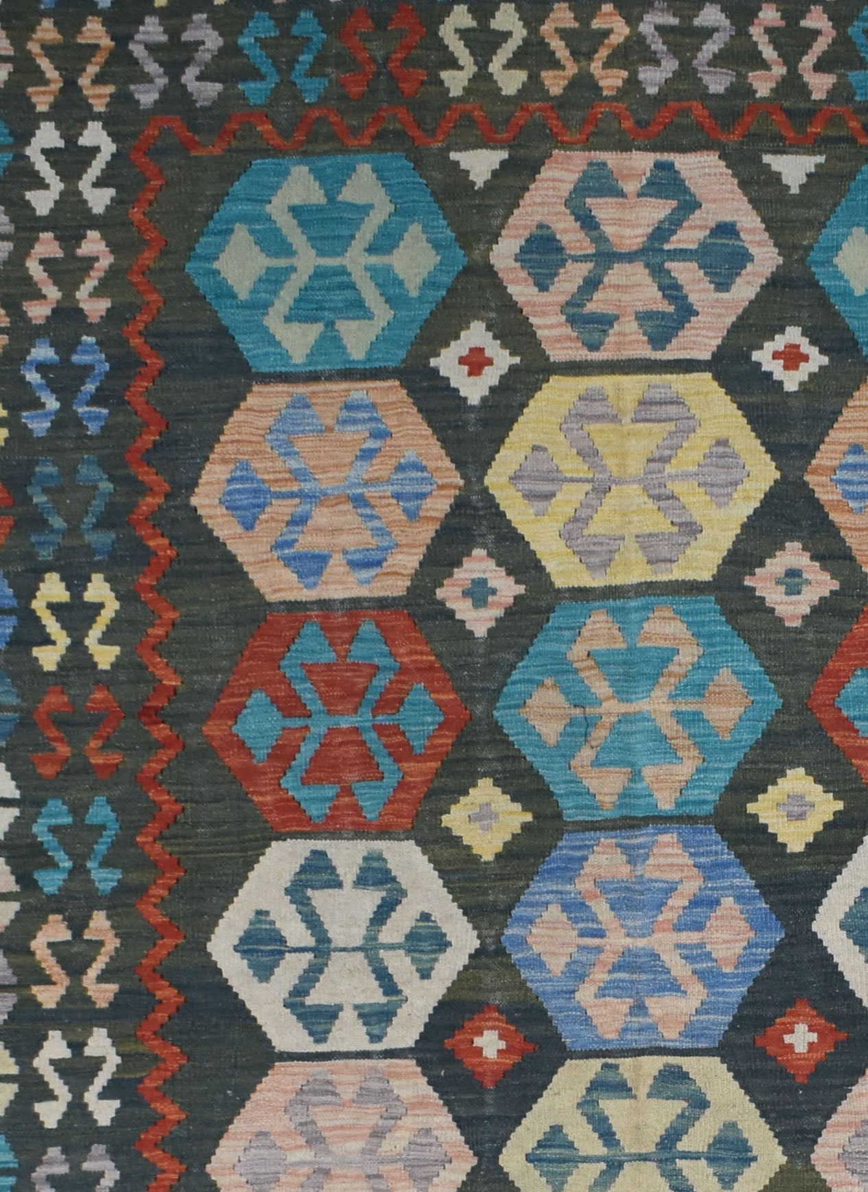 Handmade Afghan Maimana kilim rug featuring a dark background with colorful geometric hexagons.
