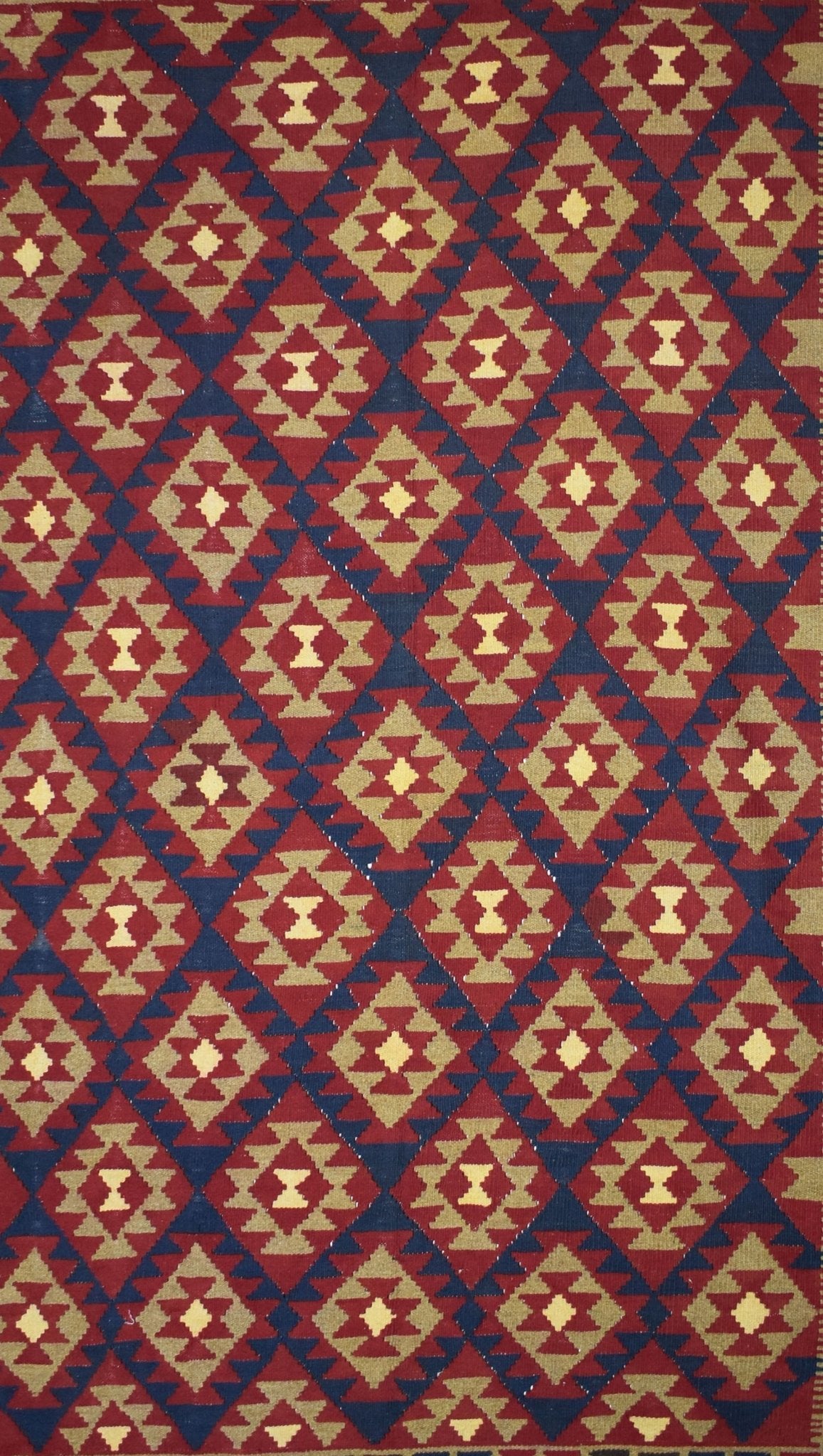 Handmade Afghan Maimana kilim rug featuring a repeating geometric diamond pattern in red and tan.