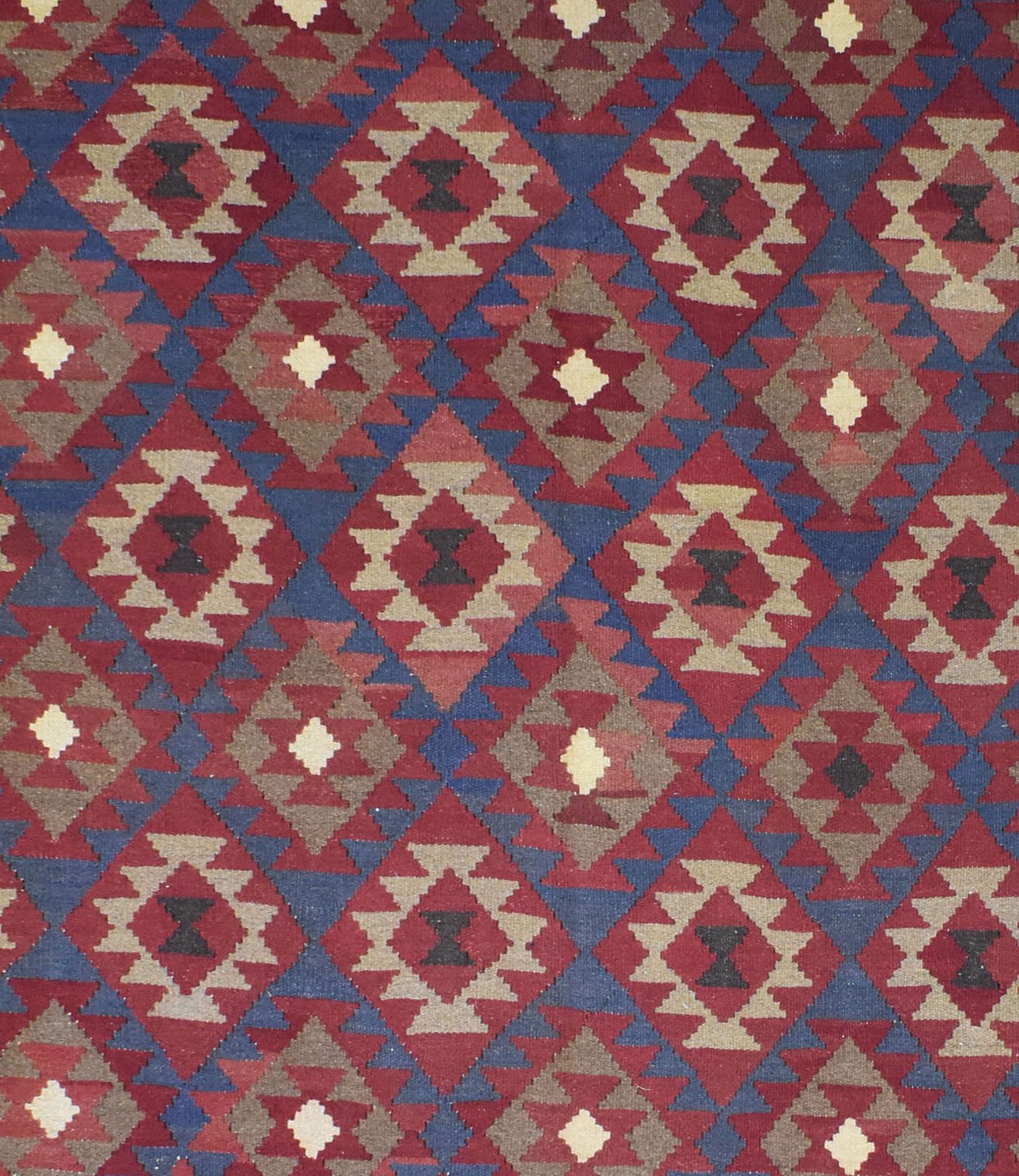 Handmade Afghan Maimana kilim rug featuring a repeating geometric diamond pattern in earthy tones.