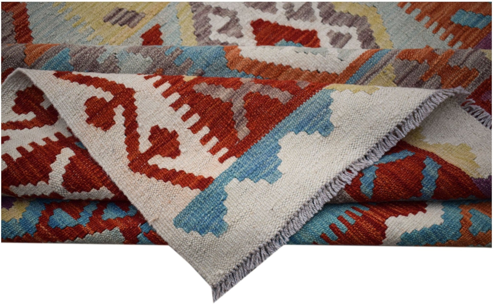 A handwoven Afghan Maimana kilim rug featuring geometric patterns in red, blue, and cream tones.
