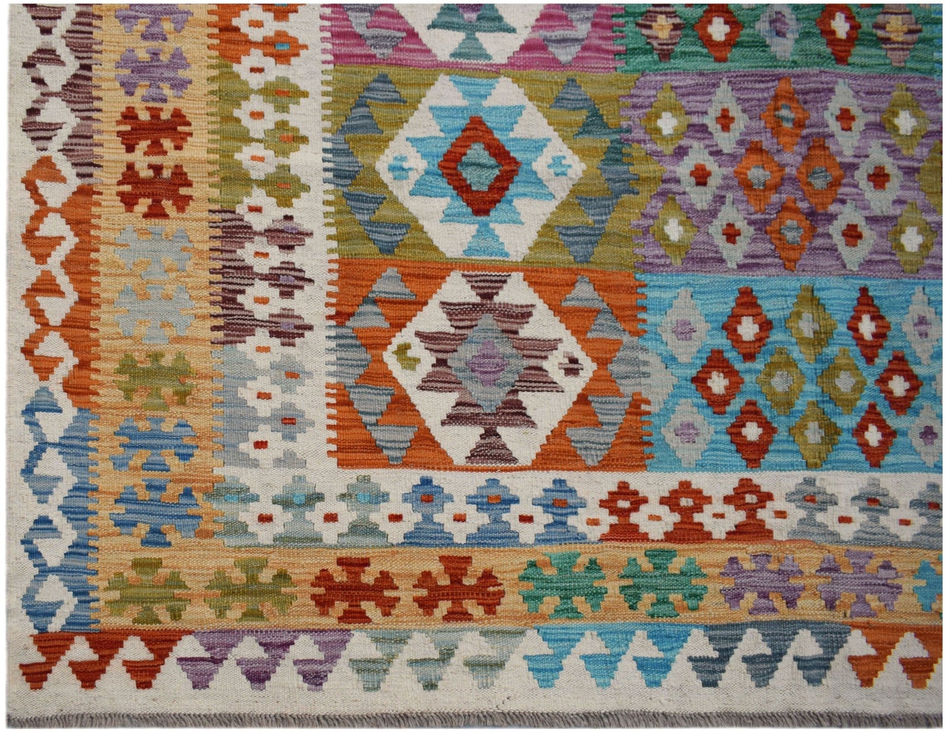 Handwoven Afghan Maimana kilim rug featuring a vibrant geometric pattern in wool.