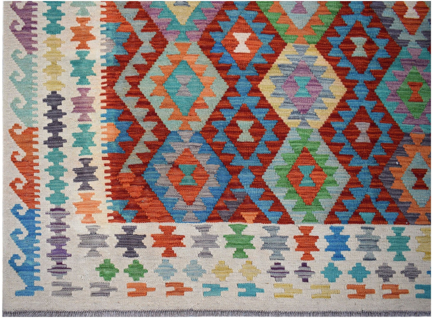 Handwoven Afghan Maimana Kilim rug featuring a vibrant geometric diamond pattern in wool.