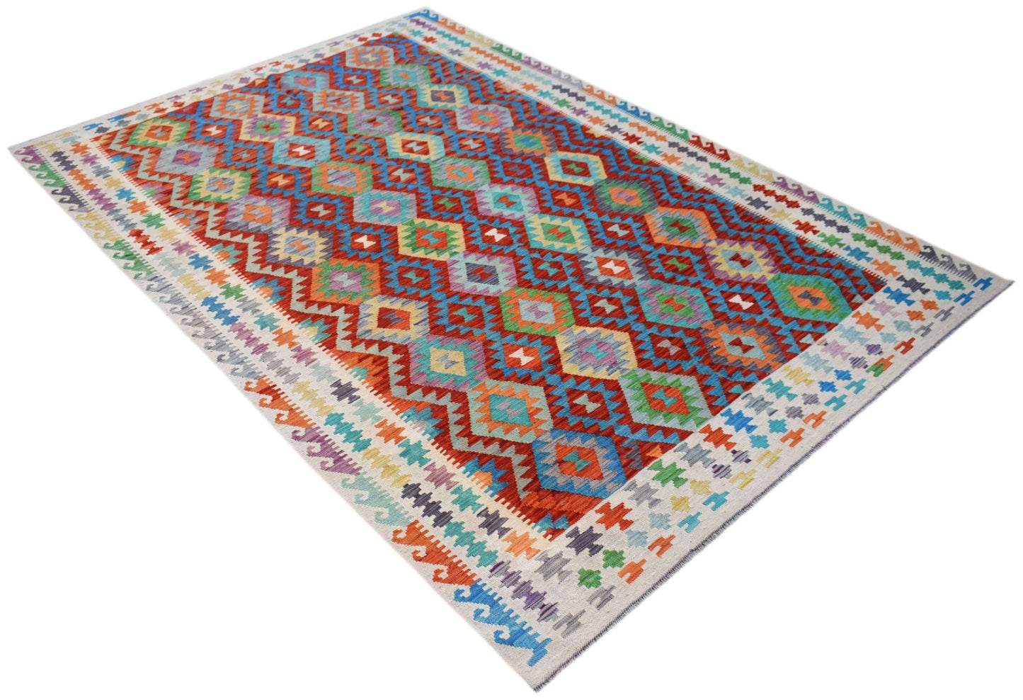 Handwoven Afghan Maimana kilim rug featuring a vibrant geometric diamond pattern in wool.