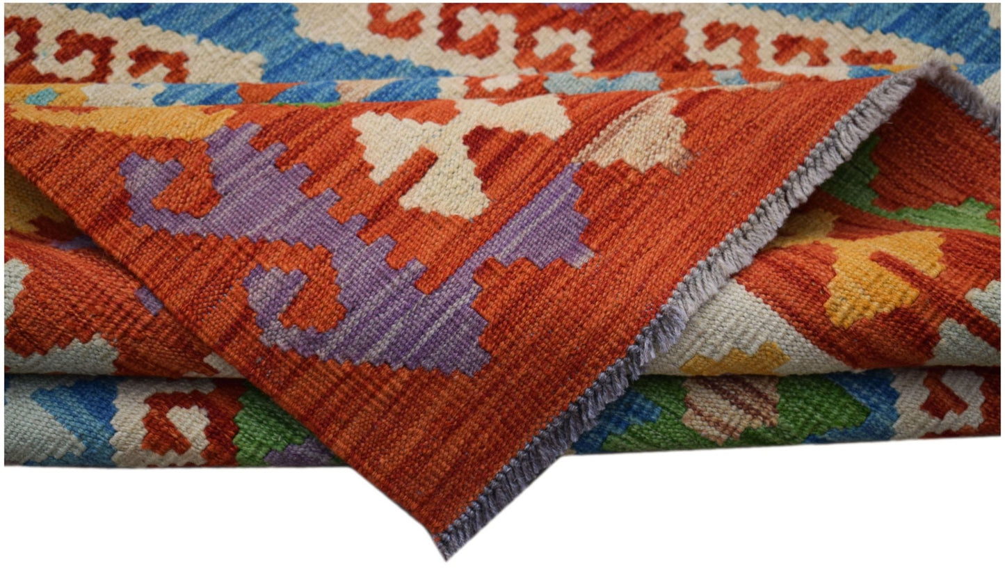 A handwoven Afghan Maimana kilim featuring a vibrant geometric pattern in wool.
