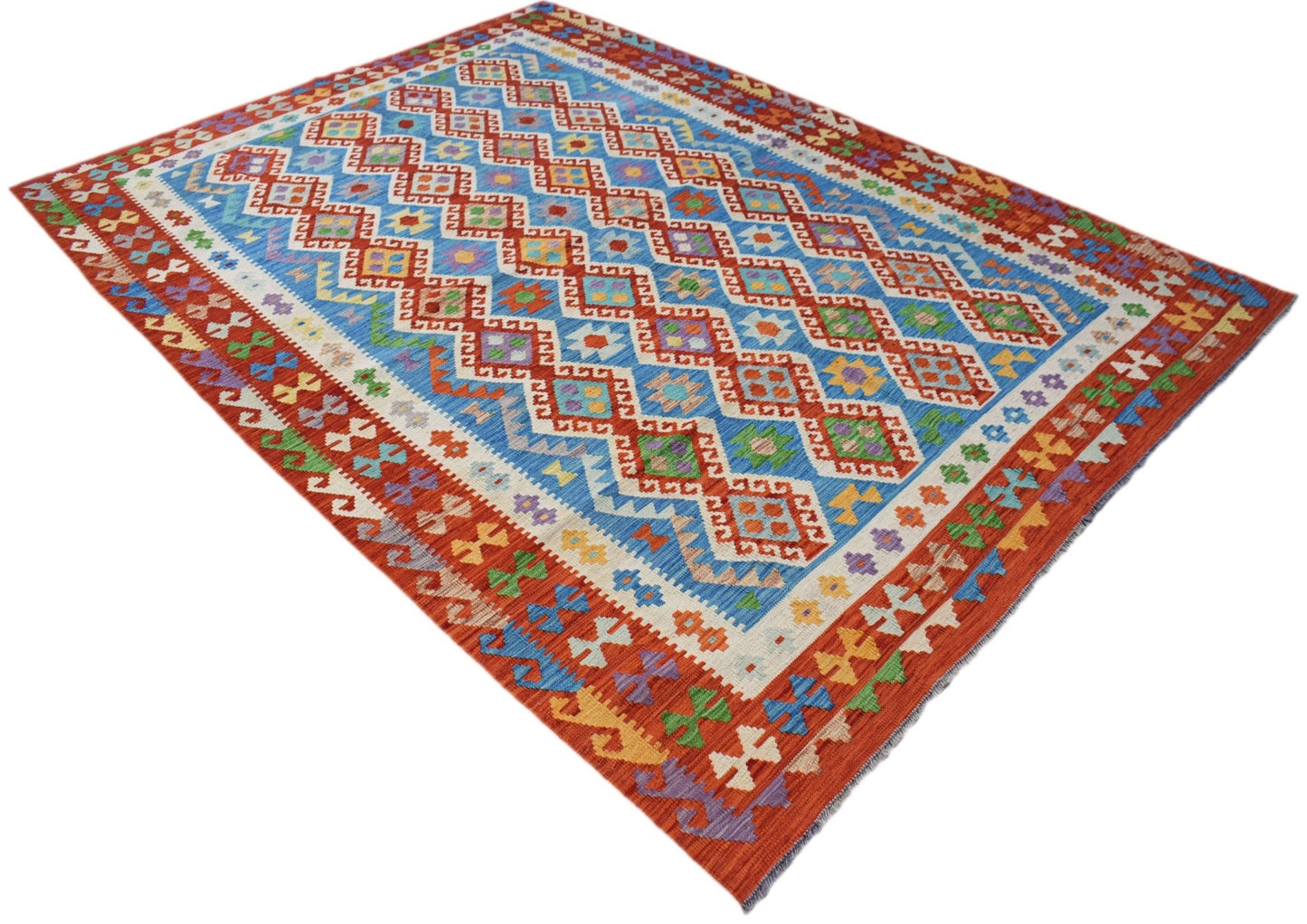 Handmade Afghan Maimana kilim rug featuring a blue field with colorful geometric diamond patterns.