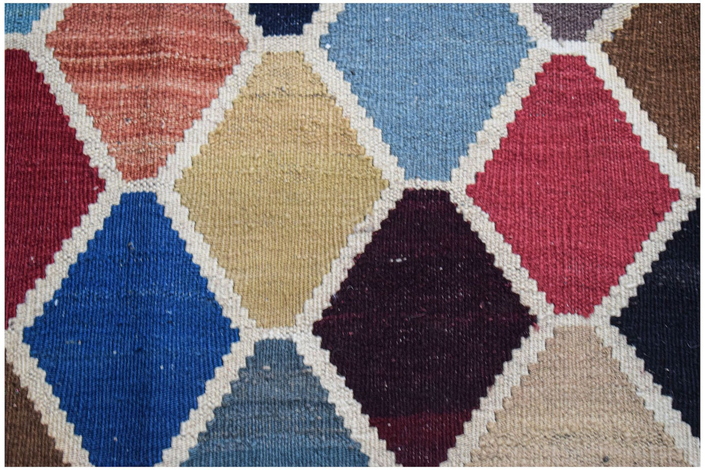 Handwoven Afghan Maimana kilim featuring a colorful geometric diamond pattern in wool.