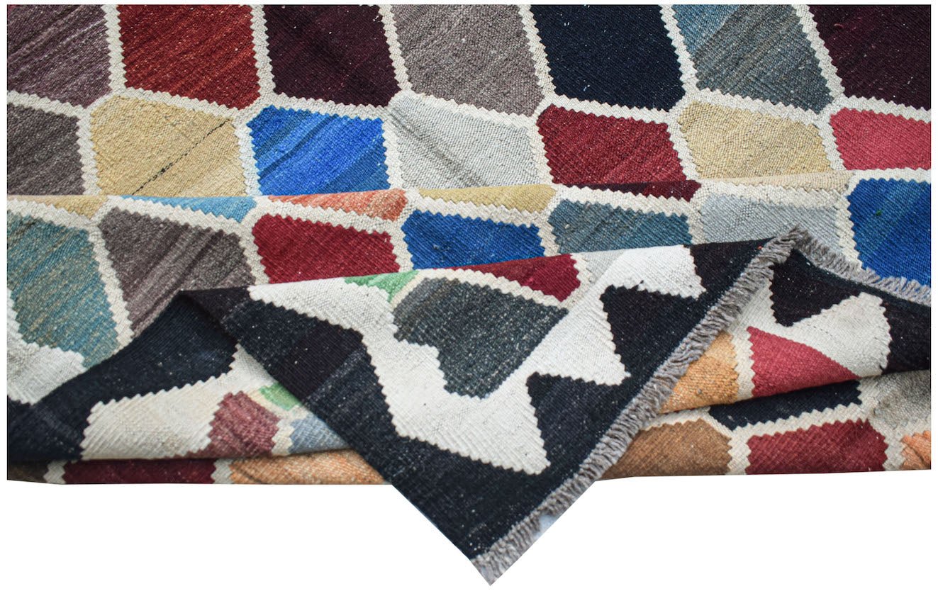 Handwoven Afghan Maimana kilim rug featuring a colorful geometric pattern and flatweave texture.