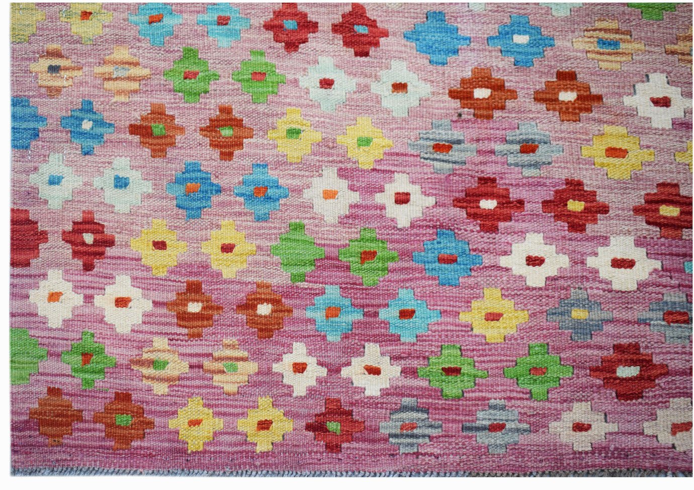 Handmade Afghan Maimana kilim rug featuring a repeating geometric pattern in vibrant colors.