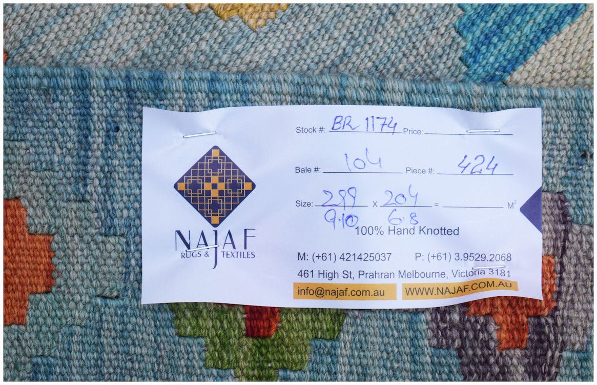 A handwoven Afghan Maimana kilim featuring a colorful geometric pattern and flatweave texture.