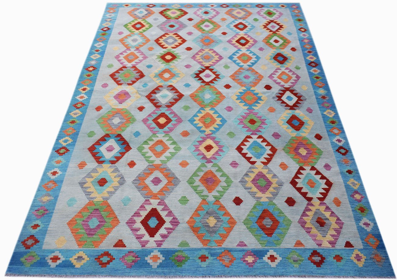 Handmade Afghan Maimana kilim rug featuring a light blue background with colorful diamond patterns.