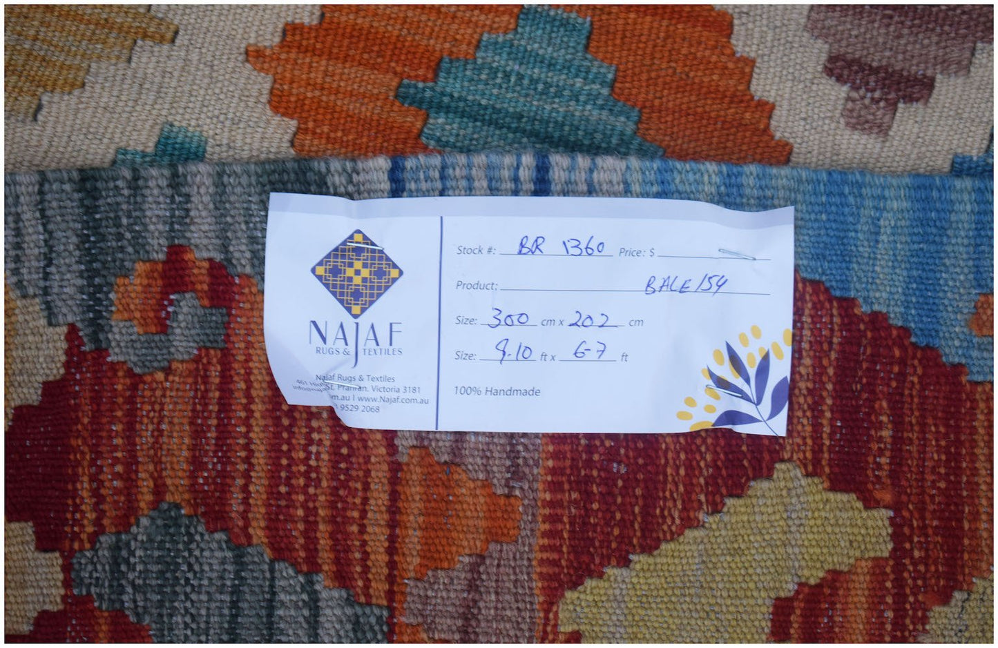 A handmade Afghan Maimana Kilim rug featuring a vibrant geometric pattern in wool.
