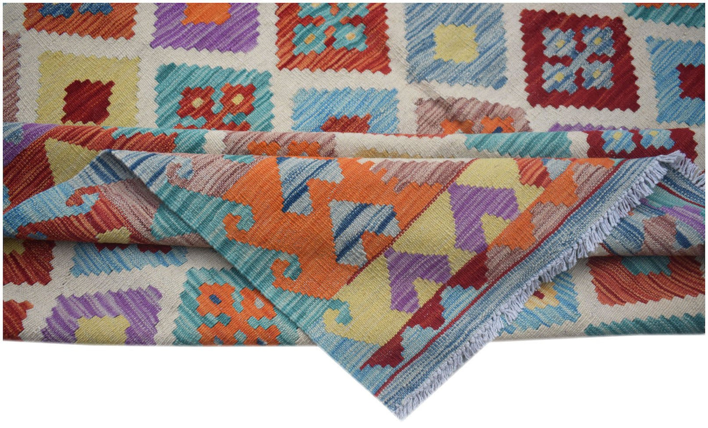 Handwoven Afghan Maimana kilim featuring a colorful geometric pattern and a flat-weave texture.