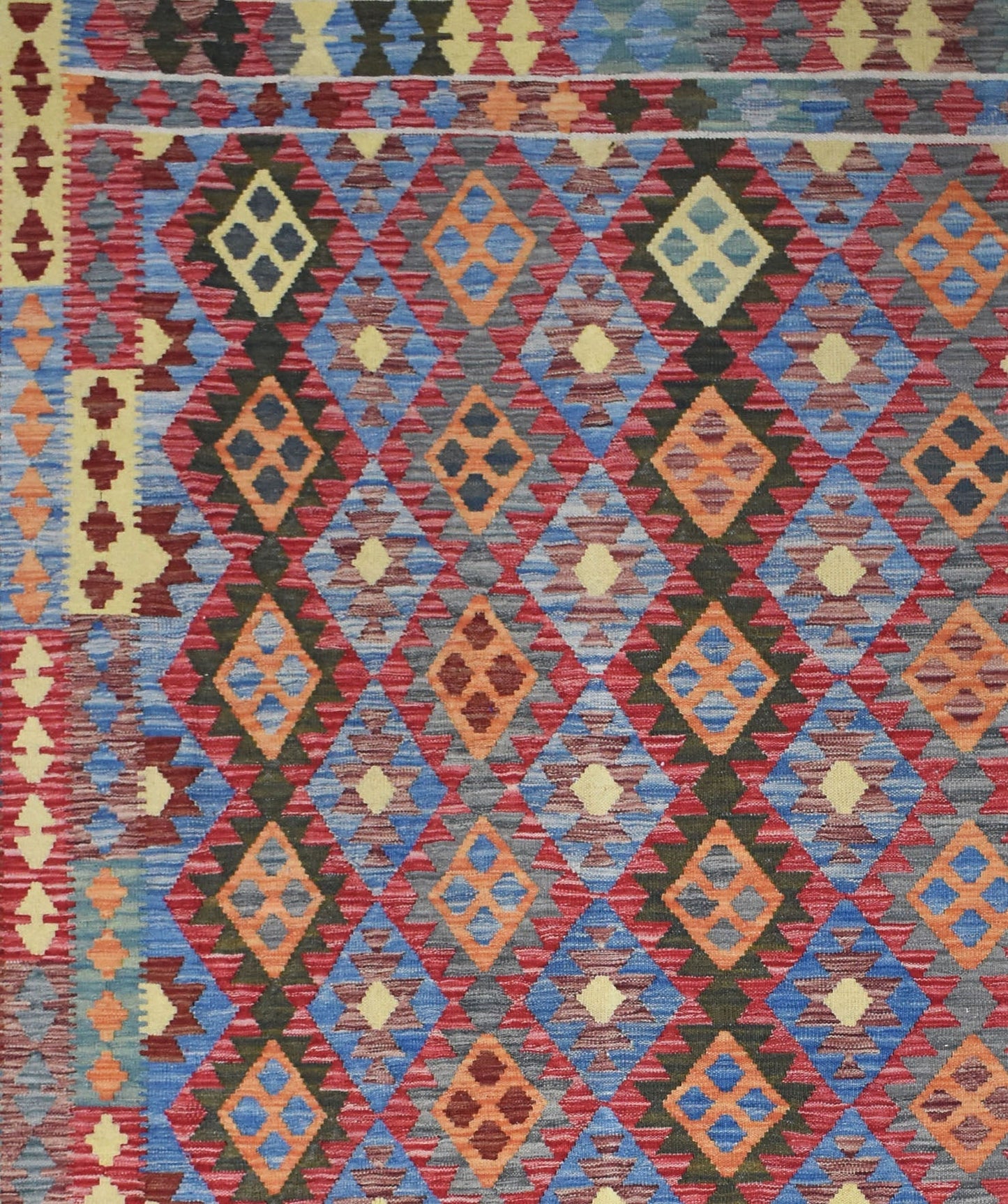 Handmade Afghan Maimana kilim rug featuring a vibrant geometric diamond pattern in wool.