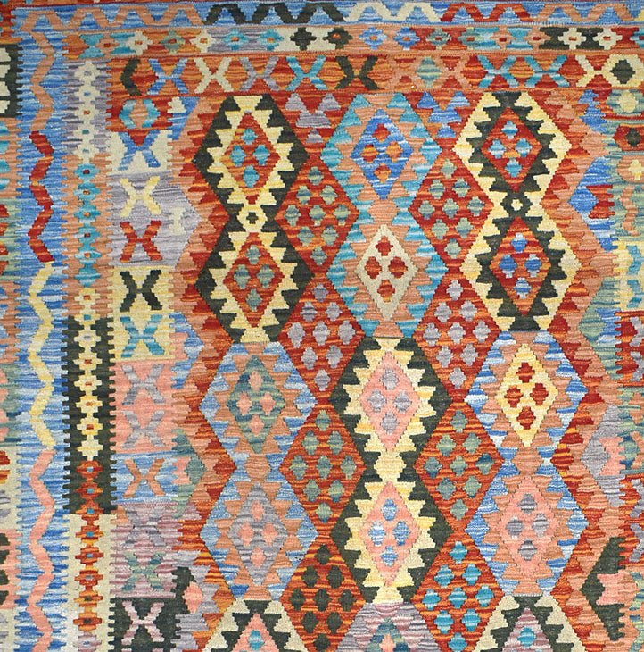 Handmade Afghan Maimana kilim rug featuring a vibrant geometric diamond pattern in wool.