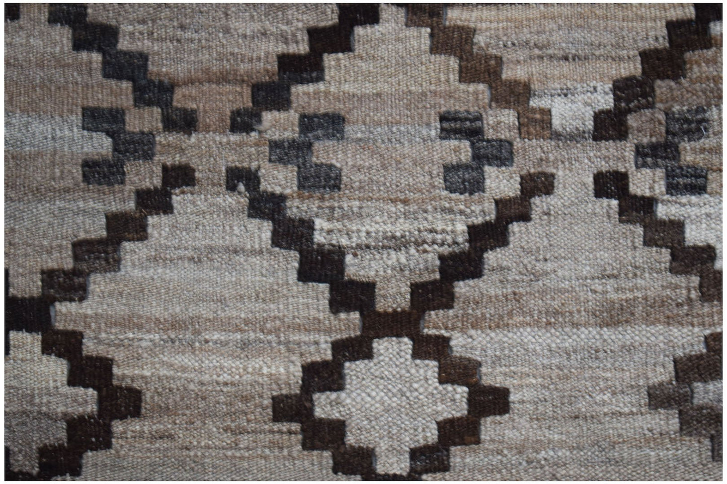 Handwoven Afghan Maimana kilim featuring a geometric diamond pattern in neutral wool tones.