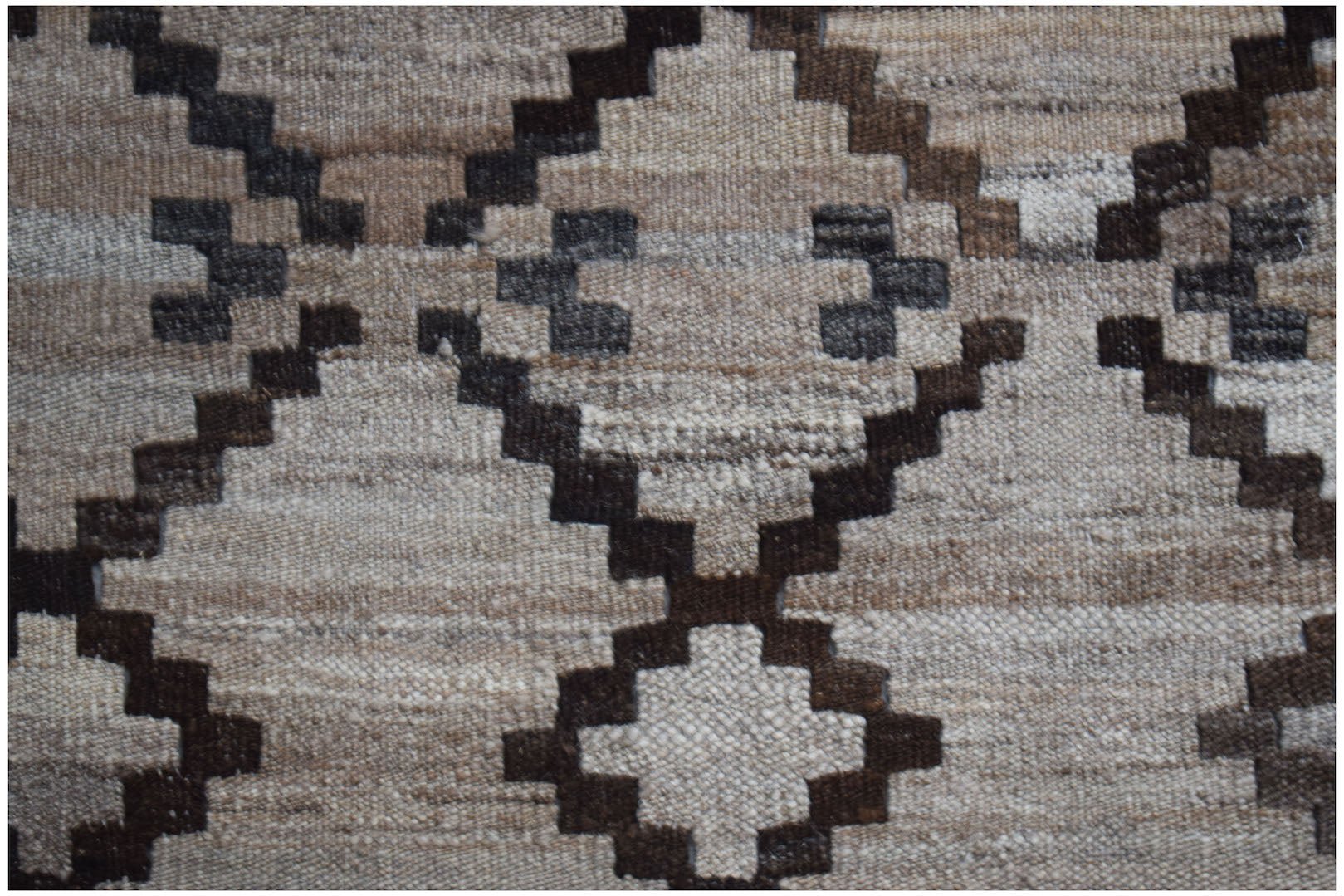 Handwoven Afghan Maimana kilim featuring a geometric diamond pattern in neutral wool tones.