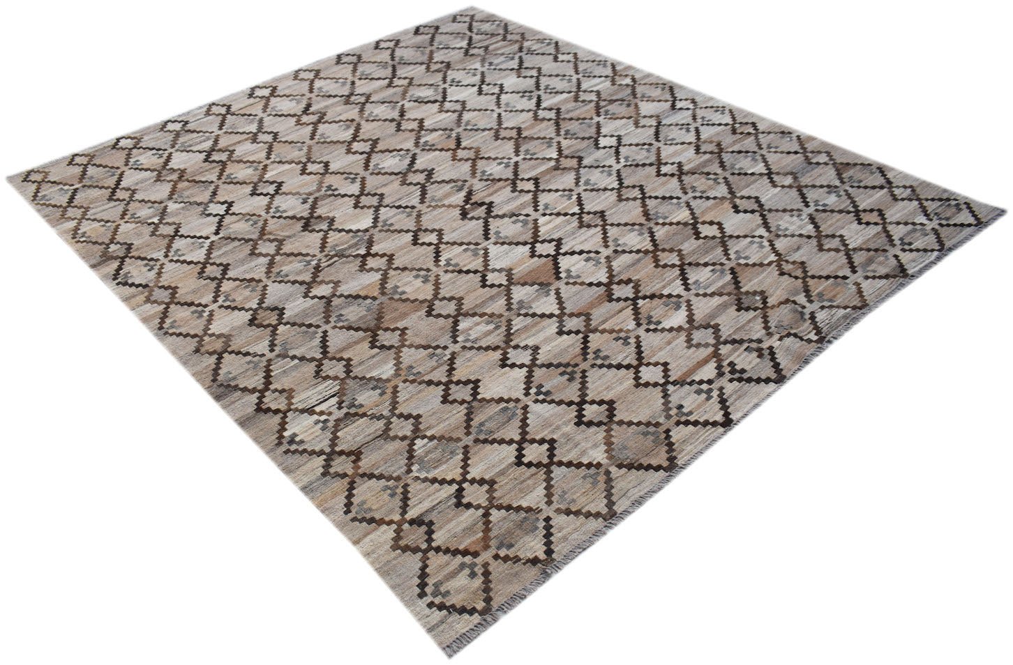 Handwoven Afghan Maimana kilim rug featuring a repeating geometric diamond pattern in neutral tones.