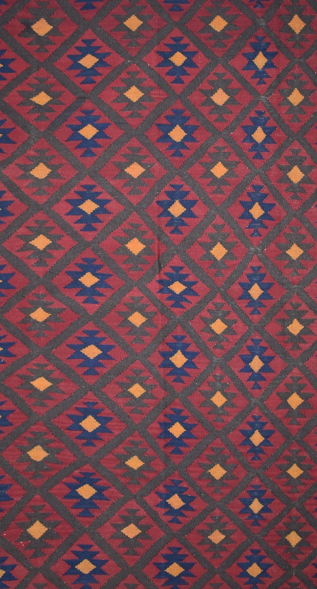 Handmade Afghan Maimana kilim rug featuring a repeating geometric diamond pattern in red and blue.