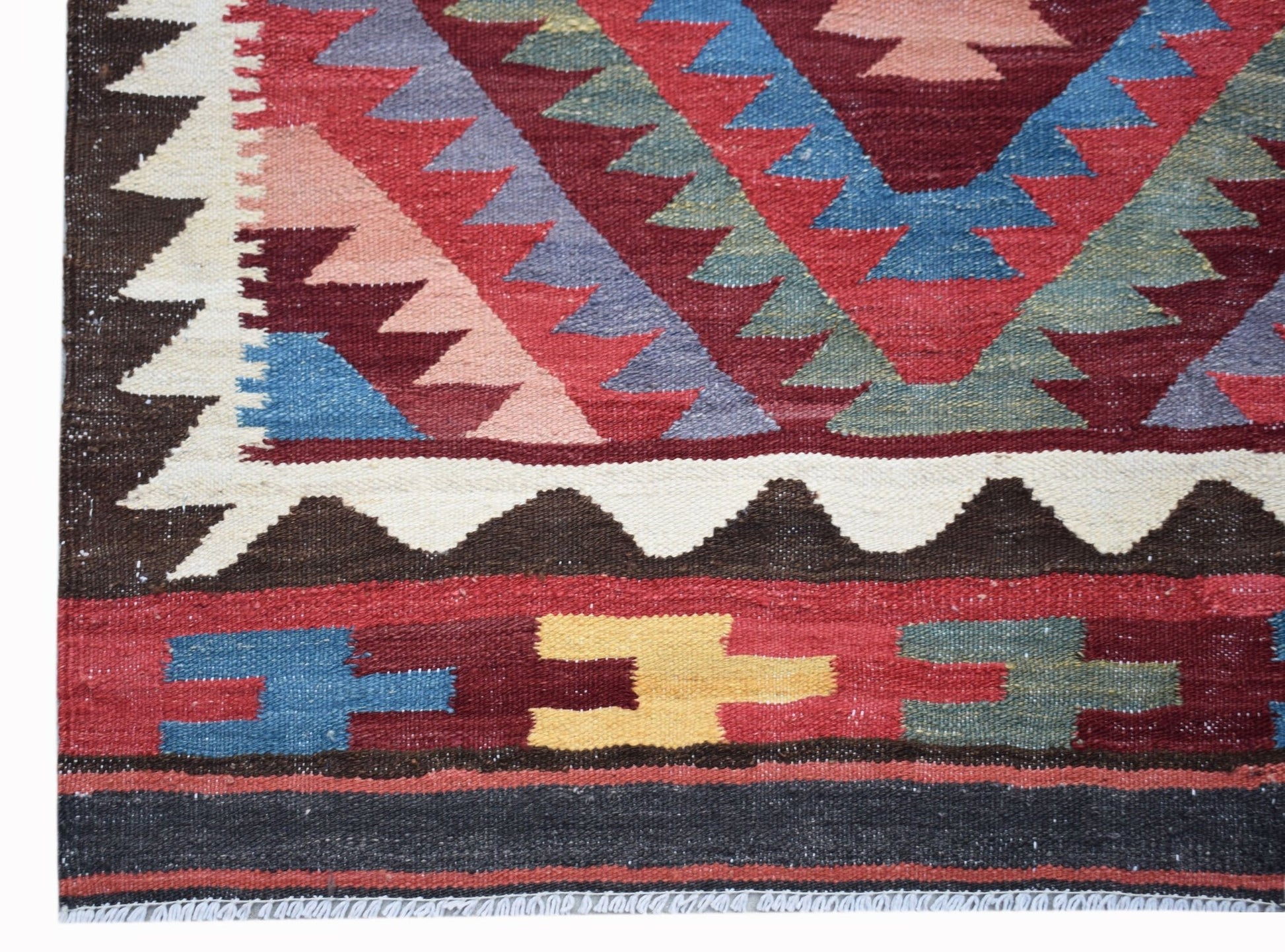 Handwoven Afghan Maimana kilim rug featuring geometric patterns in red, blue, yellow, and brown.