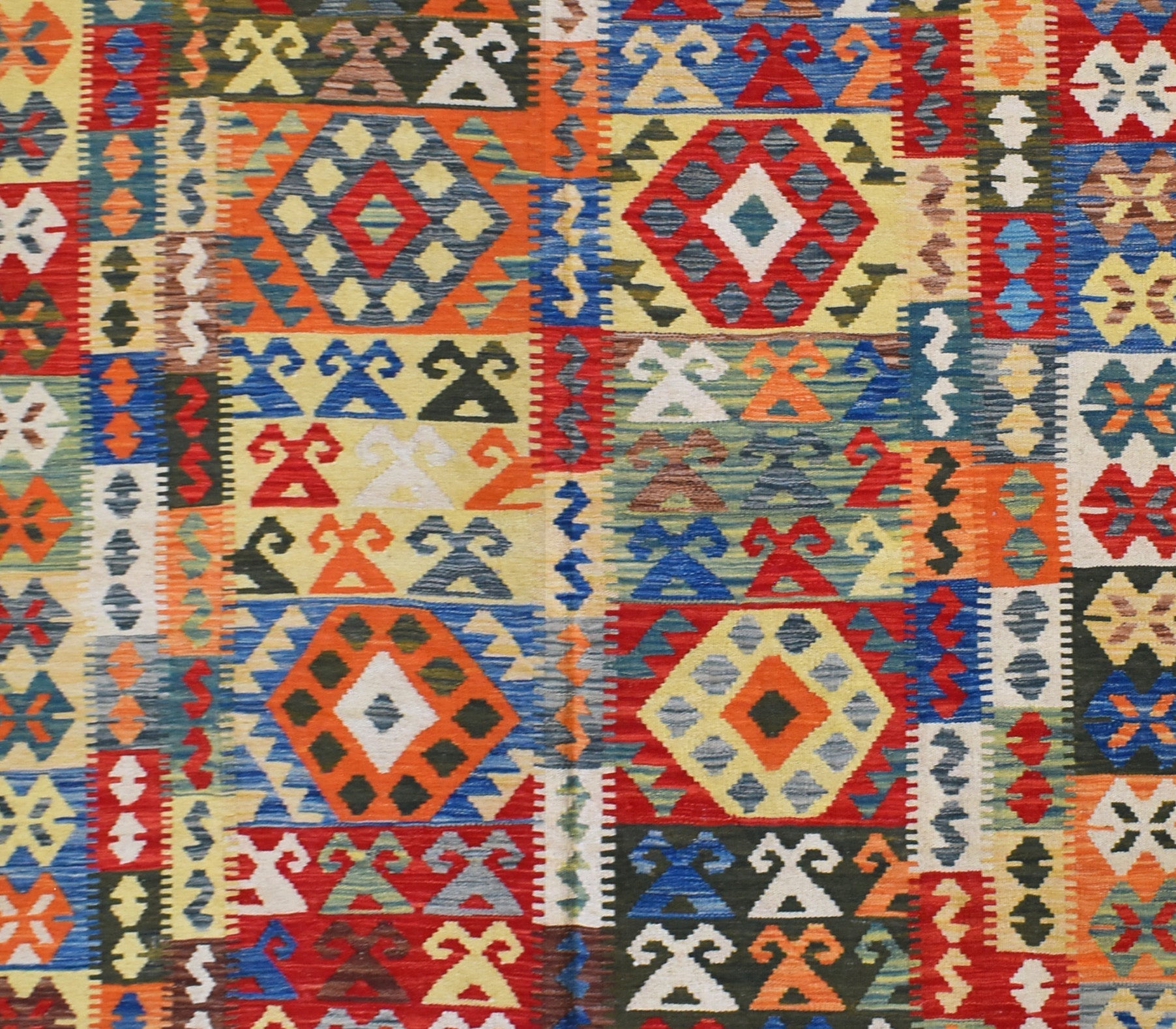 Handmade Afghan Maimana kilim rug featuring a vibrant geometric pattern in rich, multicolored wool.