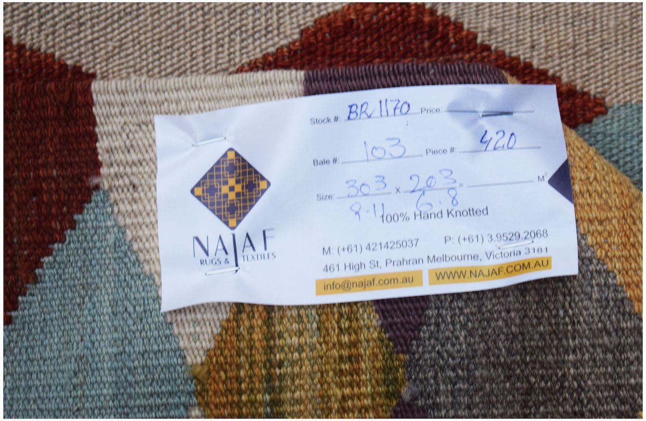 An Afghan Maimana Kilim rug featuring a geometric pattern in rich, multicolored wool.