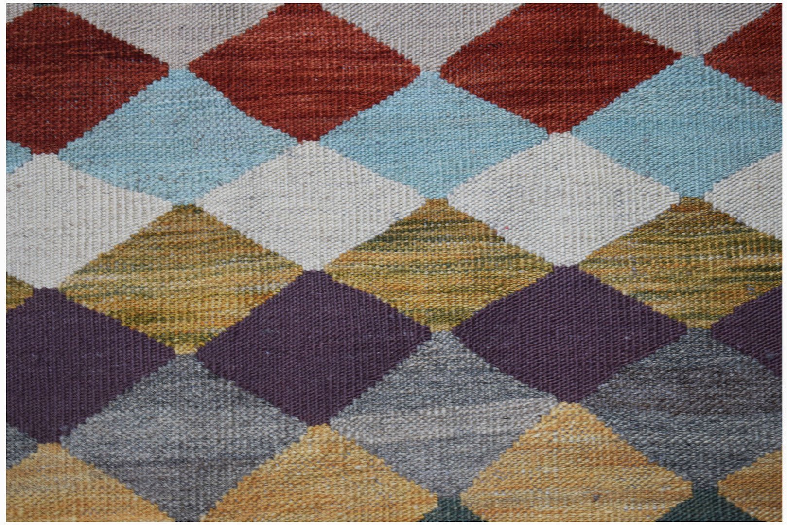 Handwoven Afghan Maimana kilim featuring a colorful geometric diamond pattern in wool.