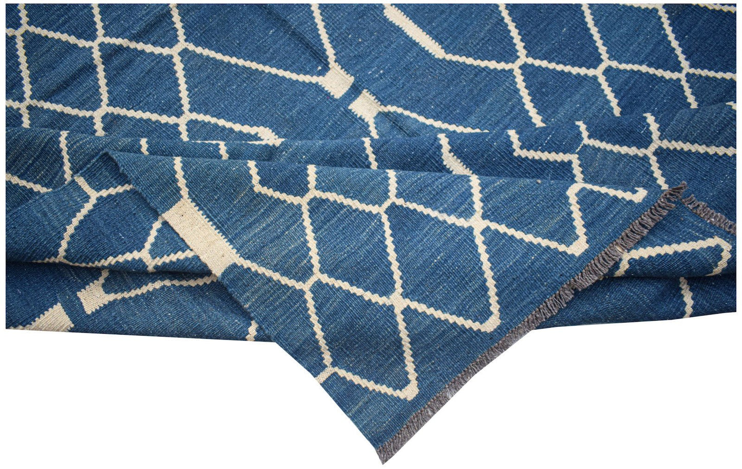 A handmade Afghan Maimana kilim rug featuring a blue field with a cream geometric diamond pattern.