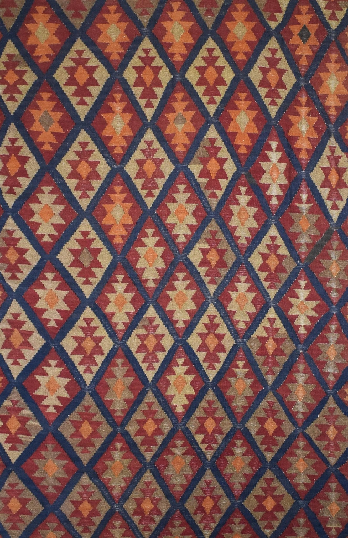 Handmade Afghan Maimana kilim rug featuring a repeating diamond pattern in red, blue, and tan.