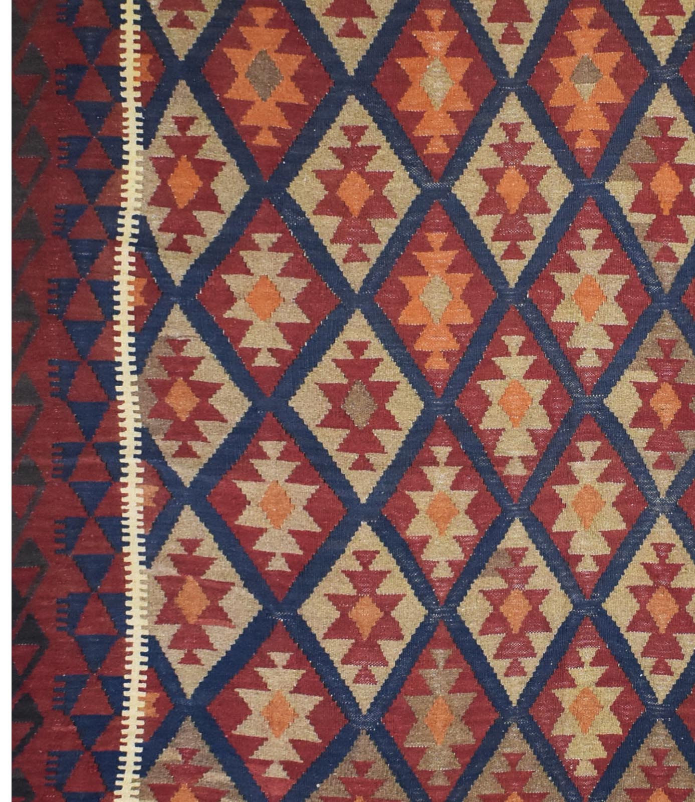 Handmade Afghan Maimana kilim rug featuring a geometric diamond pattern in red, blue, and tan.