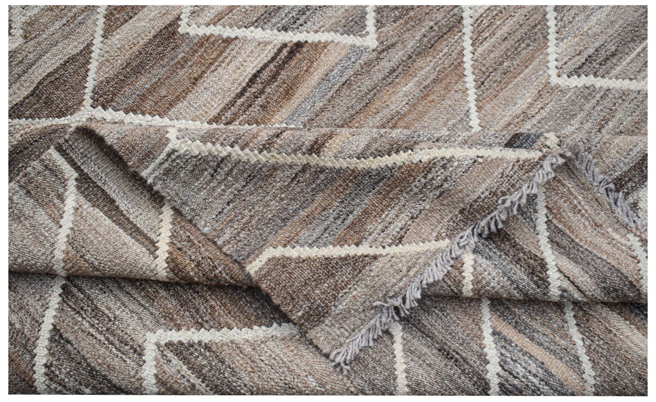 A handwoven Afghan Maimana kilim featuring a geometric pattern in shades of brown and cream.