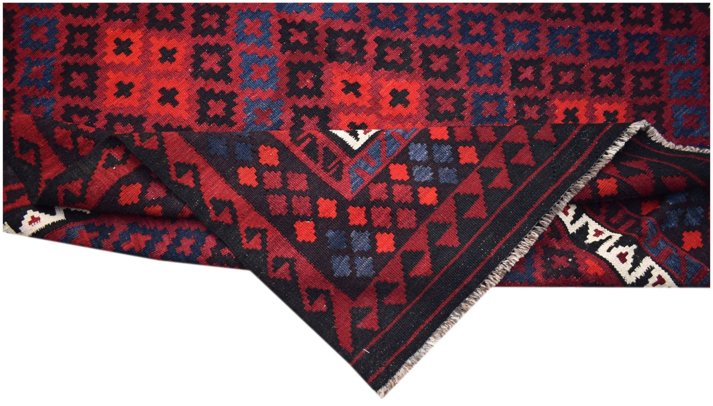 A handmade Afghan Maimana kilim featuring a geometric pattern in red, blue, and black wool.