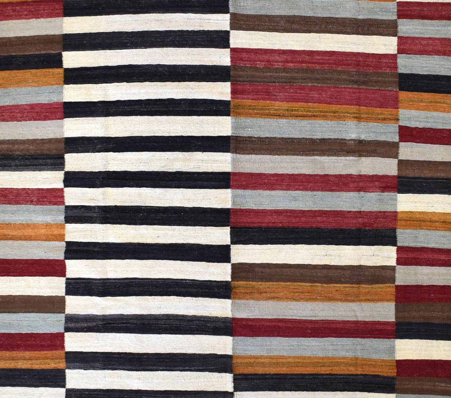 Handmade Afghan Maimana kilim rug featuring a geometric pattern of multicolored horizontal stripes.