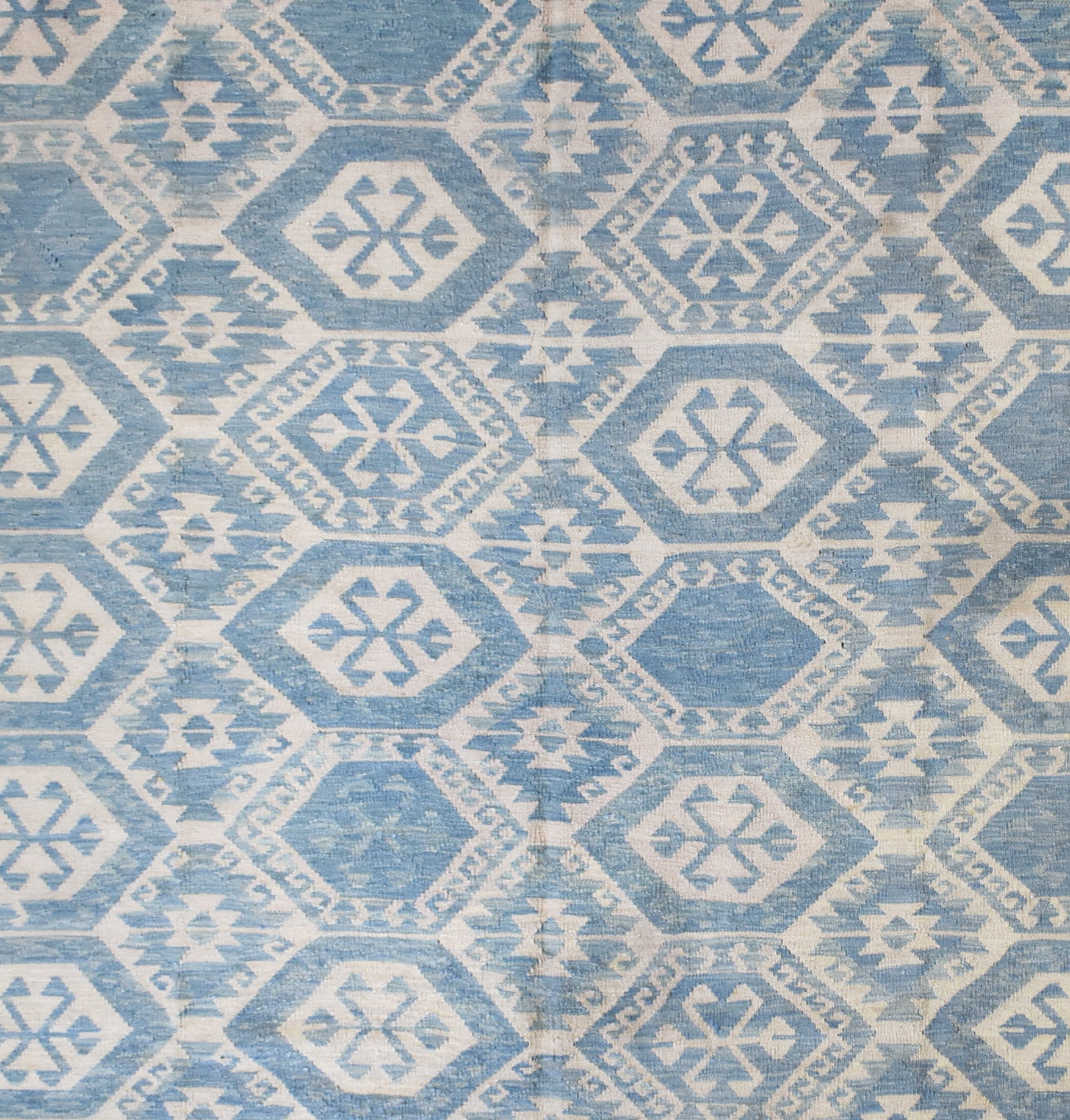 Handmade Afghan Maimana kilim rug featuring a repeating blue and white geometric pattern.