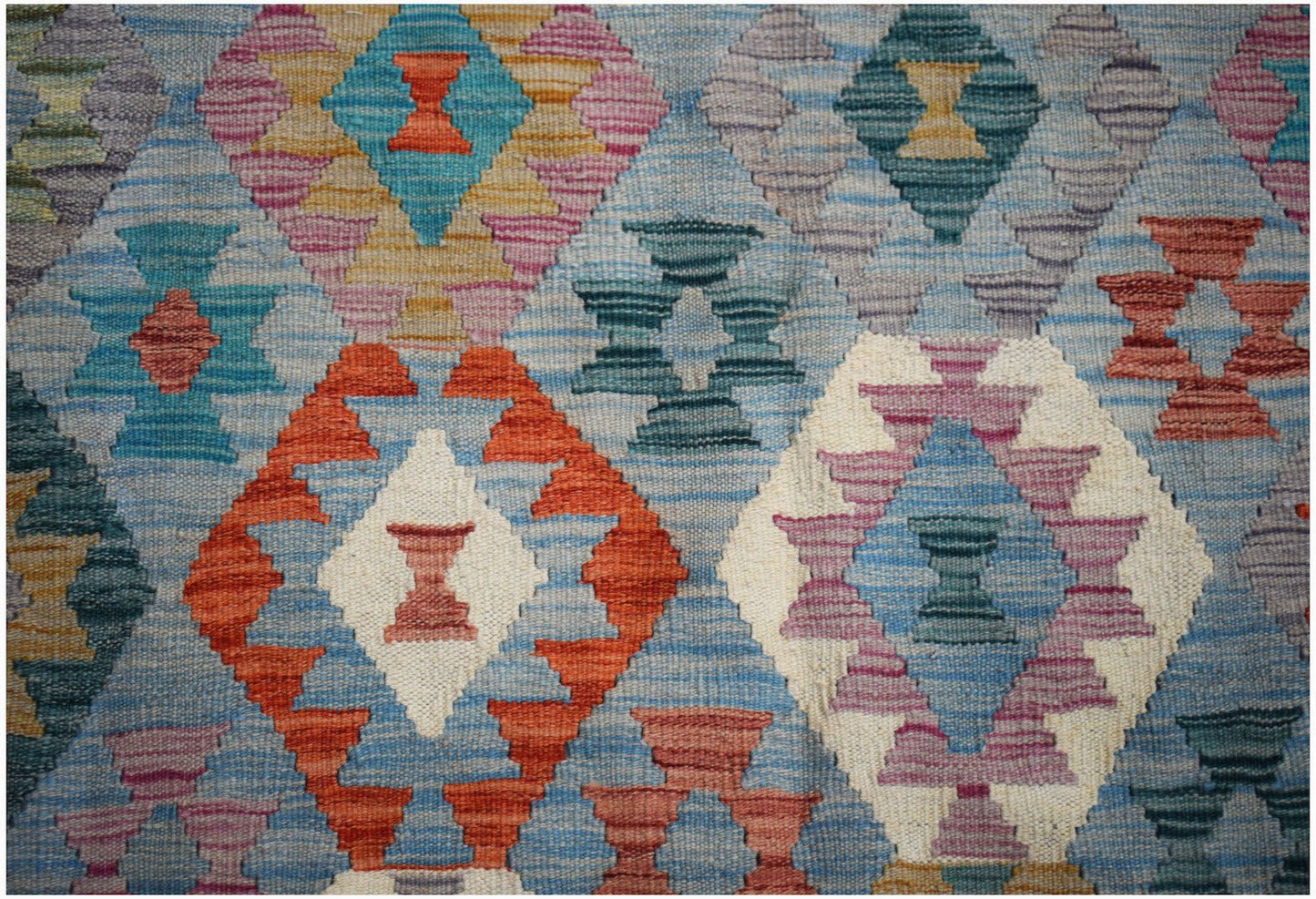 Handwoven Afghan Maimana kilim rug featuring a colorful geometric diamond pattern in wool.