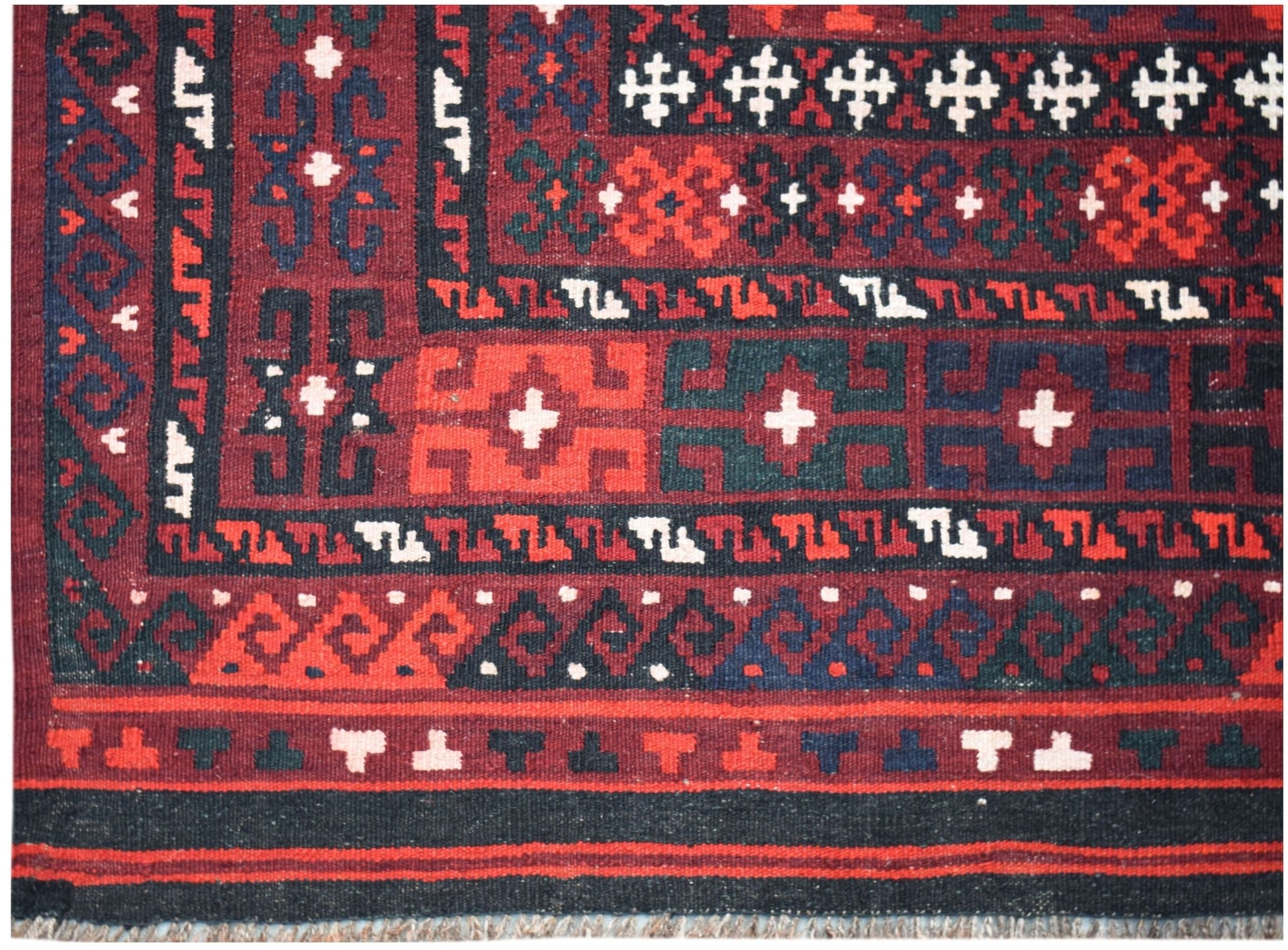 Handwoven Afghan Maimana kilim featuring geometric patterns in deep red, blue, and black wool.
