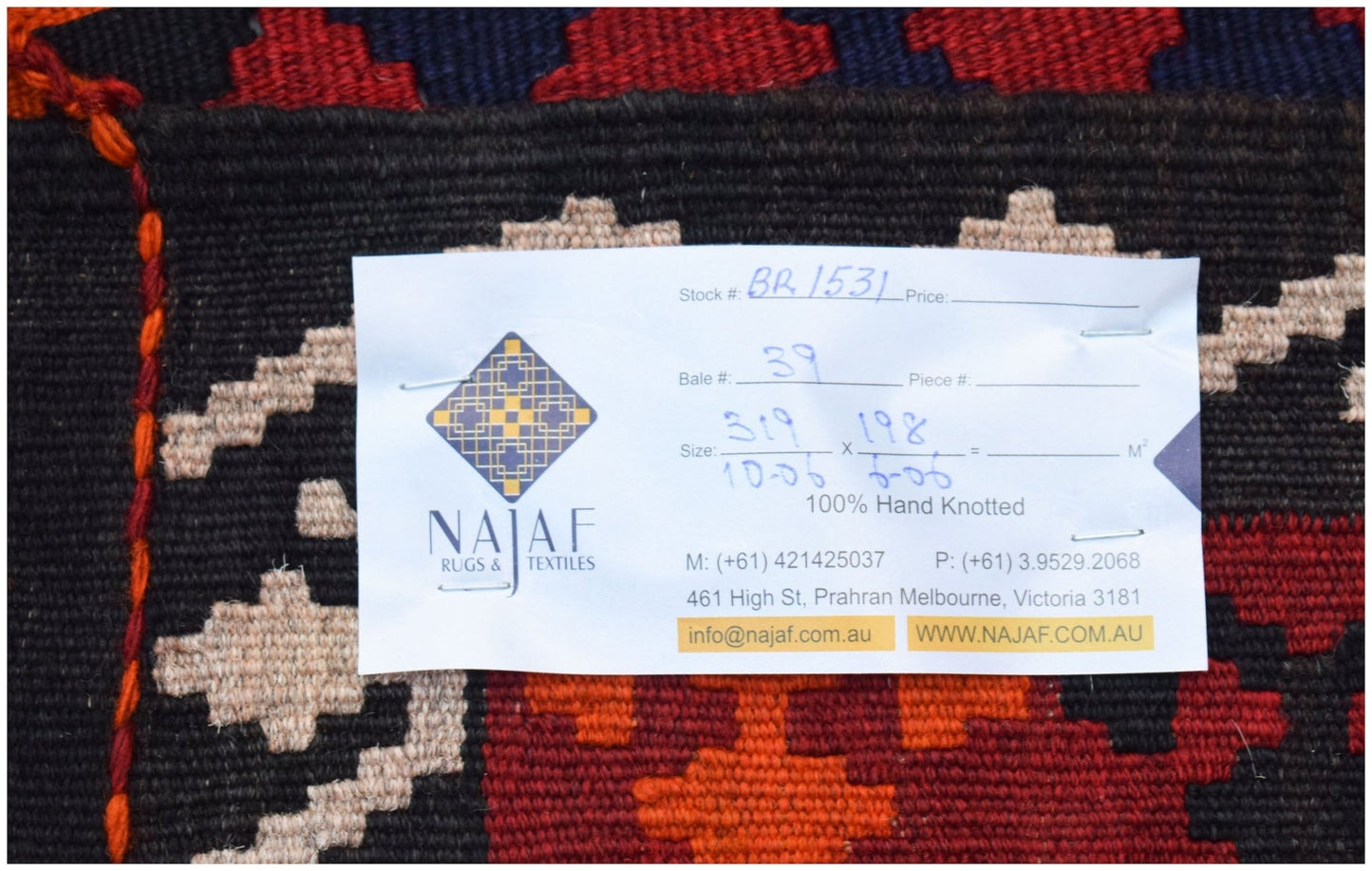 A handwoven Afghan Maimana kilim featuring a geometric pattern in red, orange, and dark tones.