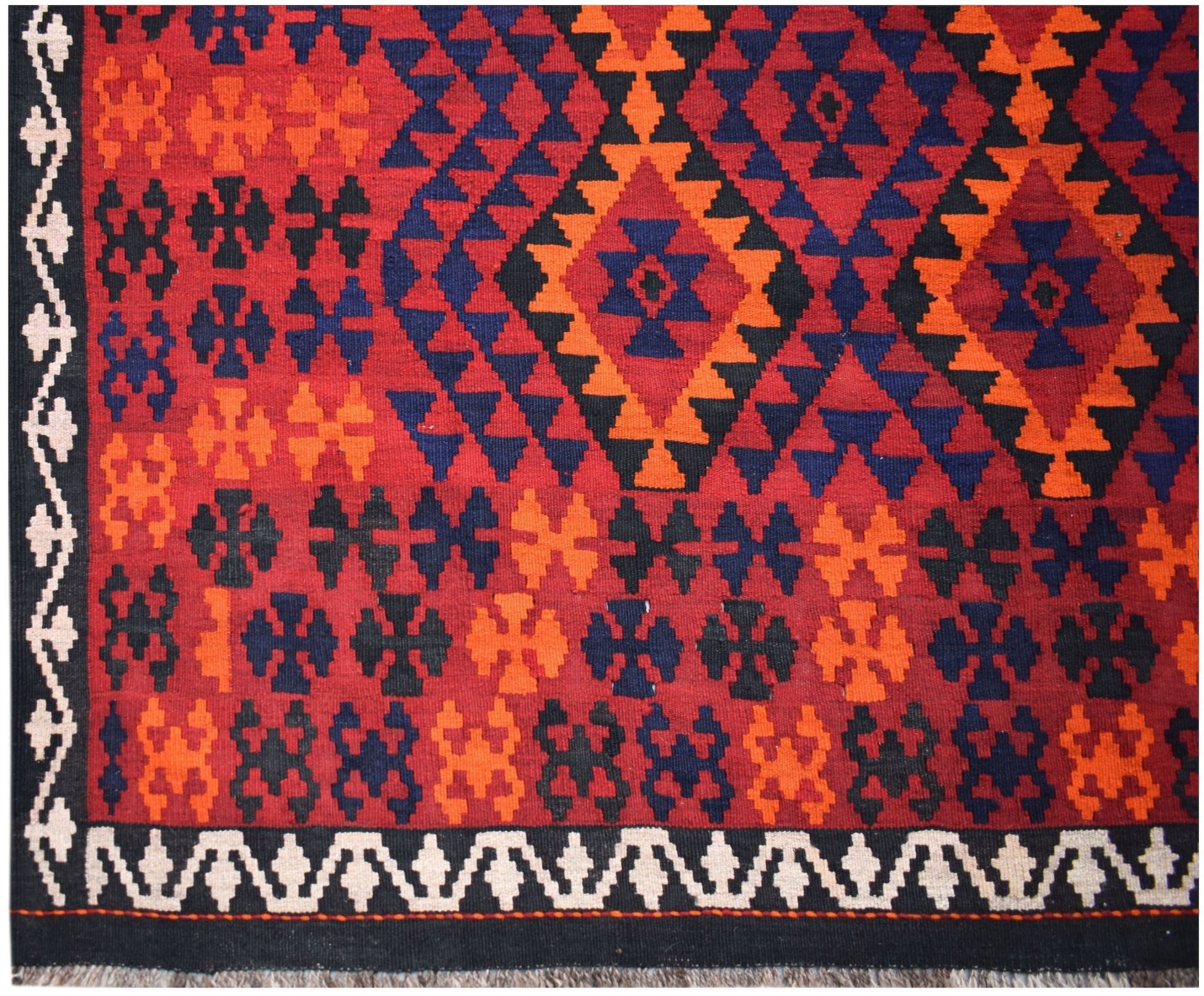 Handwoven Afghan Maimana kilim featuring a geometric pattern in red, orange, blue, and black.