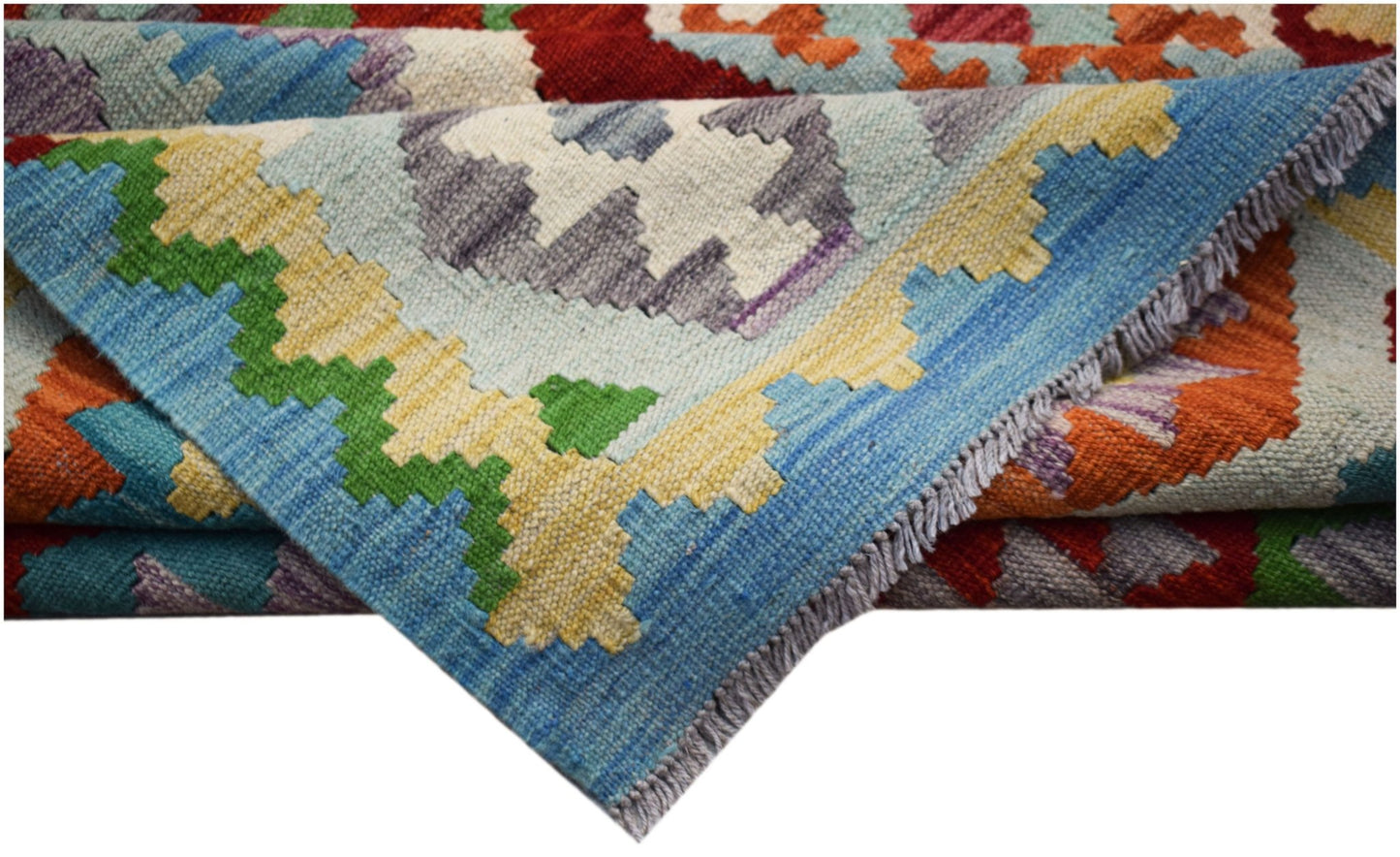 A handwoven Afghan Maimana kilim rug featuring a vibrant geometric pattern in wool.