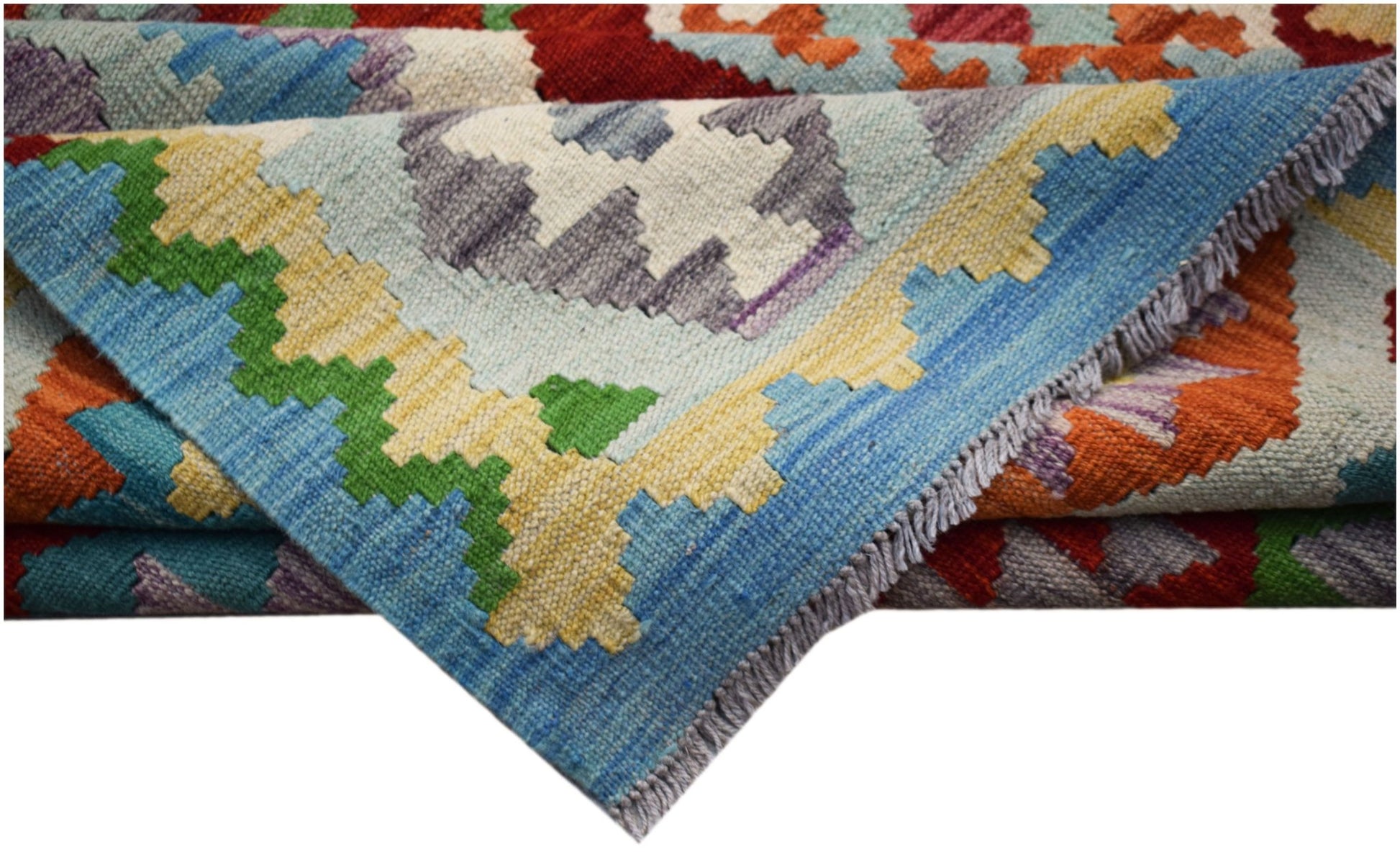 A handwoven Afghan Maimana kilim rug featuring a vibrant geometric pattern in wool.